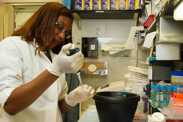 Scientist using pipette.